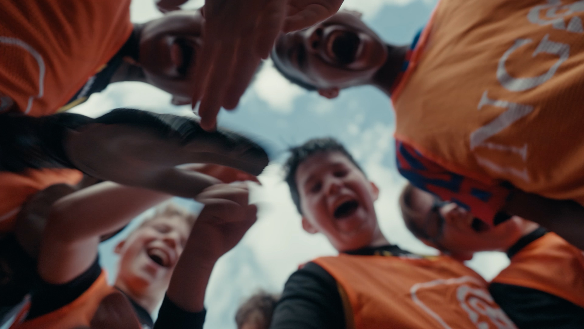 Children playing football outdoors, featured in a PuraVideos production